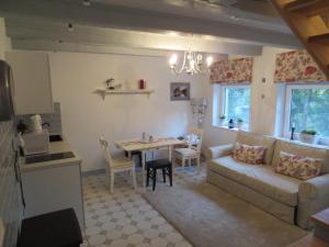 a living room with a couch and a table at Mizarai Mill House in Druskininkai +21 photos