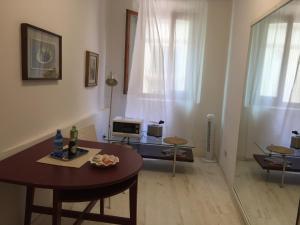 a living room with a table and a couch and a table and chairs at Duomo Residence Florence in Florence