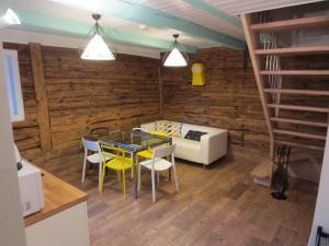 a living room with a table and chairs and a couch at Mizarai Mill House in Druskininkai