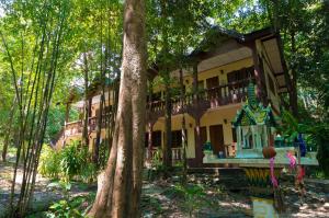 a building in the middle of a forest at The Lost Resort in Ko Samed