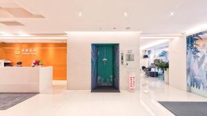 a lobby with a green door in a building at CityInn Hotel Taipei Station Branch II in Taipei