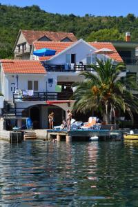 a group of people on a dock on the water at Apartments Odzic in Tivat