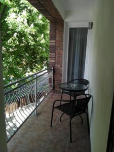 a balcony with a table and a chair on it at Cityap Apartments in Martinske Hole