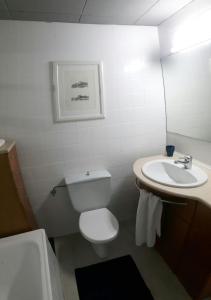 a bathroom with a white toilet and a sink at apartament Sant Pere in Sant Pere Pescador