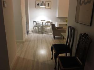 a living room with a dining room table and chairs at Calle Aduana in Madrid