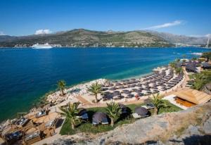 an aerial view of a beach with umbrellas and the ocean at Room with jungle bathroom in Dubrovnik