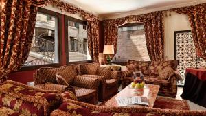 a living room with a couch and chairs and a table at Hotel Ca' Alvise in Venice