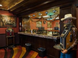 a man in a hat standing in a bar at Skyline Hotel and Casino in Las Vegas