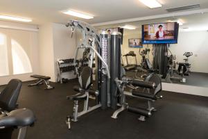 a gym with tread machines and a flat screen tv at Skyline Hotel and Casino in Las Vegas