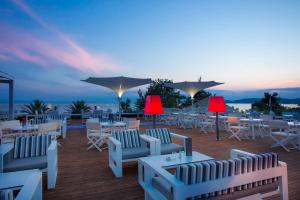 a group of tables and chairs on a deck at Alexandra Beach Spa Resort in Potos
