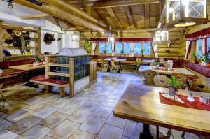 a large room with tables and chairs in a restaurant at Jaga Alm in Zell am See