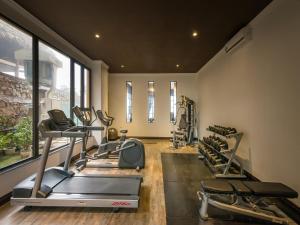 a gym with treadmills and ellipticals in a room at Aliana Boutique Sapa Hotel & Spa in Sa Pa