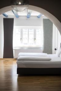 a bedroom with a bed and a large window at Dieckmann's Hotel in Dortmund