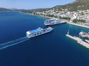 two boats are docked in a large body of water at Kekrops Hotel in Loutra Edipsou