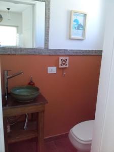 a bathroom with a sink and a toilet at Casa Ba Haus in Puerto Pirámides