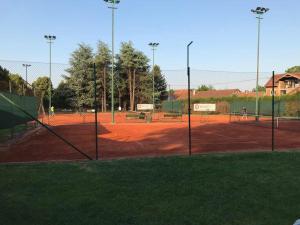 a tennis court with people playing on the court at Apartment A&D in Pančevo