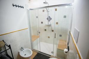 a bathroom with a shower with a toilet and a sink at La Casa Dei Ciottoli in Castelnuovo Cilento +40 photos