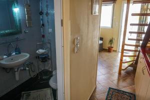 a bathroom with a sink and a toilet at Dolichi Studio in Samos