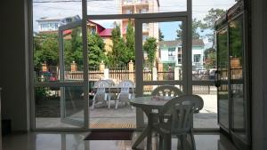 a room with a table and chairs on a patio at Hotel Aurora in Ureki