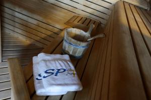 a seat in a sauna with a bucket at Alexandra Beach Spa Resort in Potos