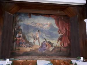 a painting on the wall in a dining room at Gasthof zum Rassen in Garmisch-Partenkirchen