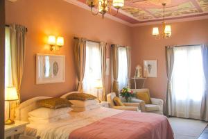 a hotel room with two beds and a window at Symi Nautilus Luxury Suites in Symi