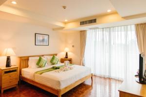 a bedroom with a bed and a large window at SeaRidge Hua Hin Resort & Poolvilla in Khao Tao