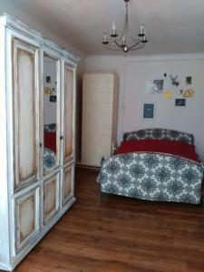 a bedroom with a bed and a dresser at Heart of Lviv in Lviv
