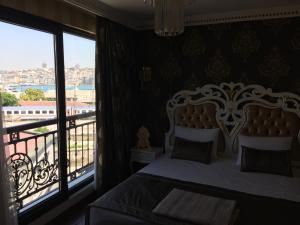 a bedroom with a bed and a balcony at Gulhane Garden Hotel in Istanbul