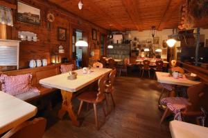 a restaurant with a table and chairs in a room at Dammschenke Gasthof & Hotel in Kurort Jonsdorf
