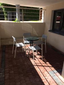 a table and chairs sitting on a patio at Apartamenty Rodzinne Puck Katarzyna Pietruszkiewicz in Puck