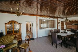 a living room with a table and a couch at Casa Dan & Lili in Şura Mică