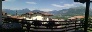 a view from a balcony of a town with mountains at Villetta Casale in Comano Terme