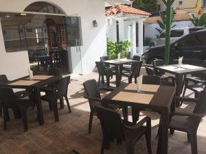 a row of tables and chairs at a restaurant at Hotel Santander SD in Santo Domingo