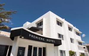 a large white building with a clock on the front of it at Premiere Hotel in Fort Lauderdale