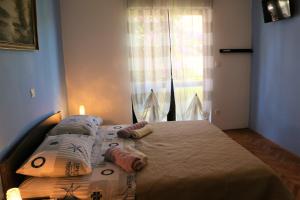 Postel nebo postele na pokoji v ubytování Apartments Milatic