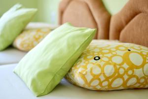 a group of pillows on a bed at Apartments Villa Milna 2 in Budva