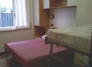 Postel nebo postele na pokoji v ubytování Hotel Parigi