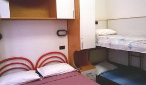 Postel nebo postele na pokoji v ubytování Hotel Parigi