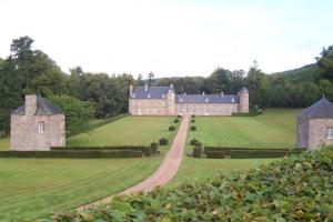 a large castle on a green field with a road at Orbigny Vakantiewoningen in Saint-Pierre-la-Vieille +19 photos