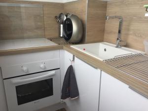 a small kitchen with a sink and a microwave at Studio Bord de Mer et VUE sur MER WIFI OFFERT in La Seyne-sur-Mer +164 photos