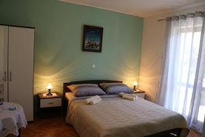 Postel nebo postele na pokoji v ubytování Apartments Milatic