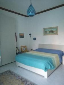 ein Schlafzimmer mit einem Bett und einem Kreuz an der Wand in der Unterkunft Garden Bijou with Sea View in Vietri