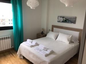 Łóżko lub łóżka w pokoju w obiekcie Alojamiento La Rosaleda