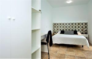 a bedroom with a bed and a closet at Quintero Suites in San Bartolomé