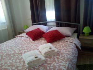 a bed with red and white towels on it at Holiday Home Julian Alps in Bovec