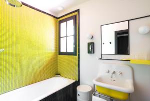 a bathroom with a tub and a sink at La Guitoune in Pyla-sur-Mer +50 photos