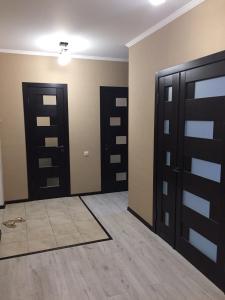 an empty room with two doors and a tile floor at Apartment on Parkovaya in Chornomorsk