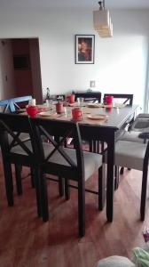 a dining room table with chairs and a table cloth at La casa de Silvia in Puerto Madryn