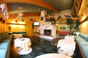a restaurant with two tables and a fireplace at Overhalla Hotel in Overhalla 